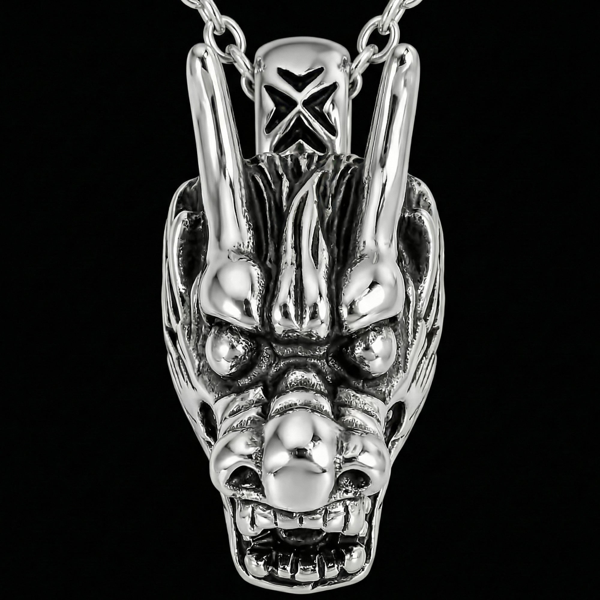 Front on view of stainless steel horned dragon head necklace.