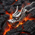 Stainless steel horned dragon head necklace on hot lava coals.