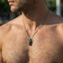 Man looking to the left wearing stainless steel horned dragon head necklace.