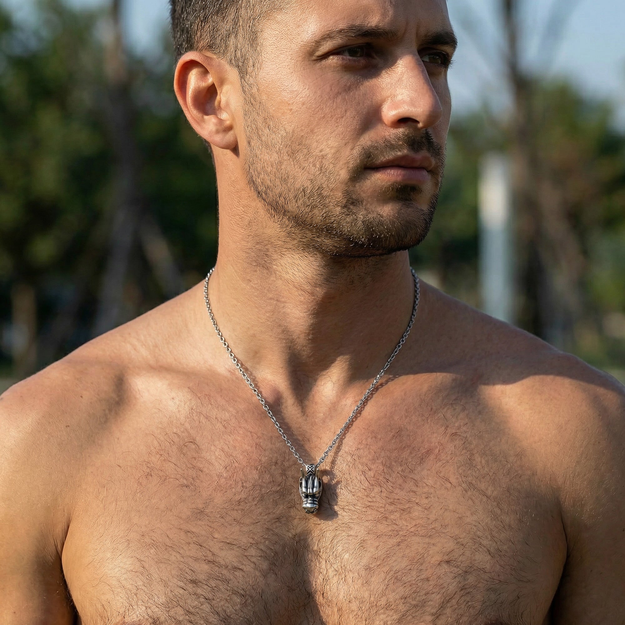 Man wearing stainless steel horned dragon head necklace.