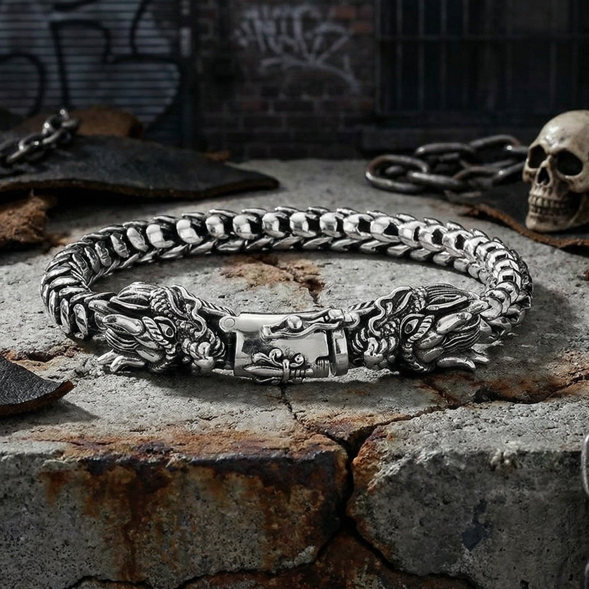 Hydra dragon sterling silver bracelet on broken concrete in an industrial grunge setting.