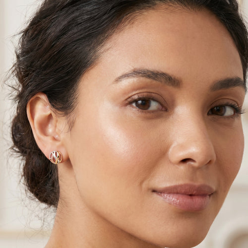 Woman wearing Engelsrufer infinity paradise tricolour cz circle earrings.
