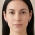 Woman wearing a pair of Engelsrufer infinity paradise silver CZ hoop earrings.