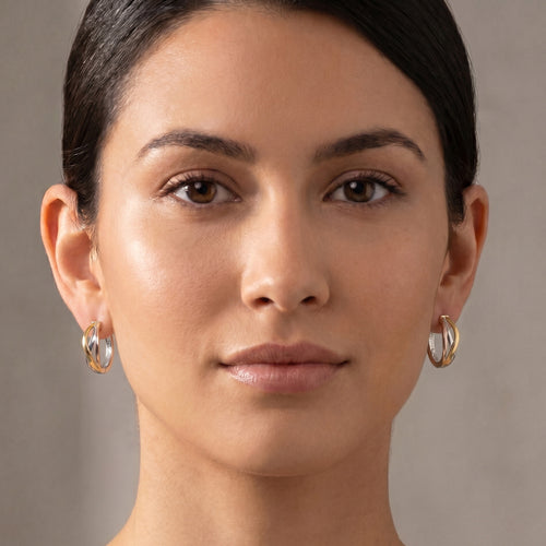 Woman wearing a pair of Engelsrufer infinity paradise tricolour hoop earrings.