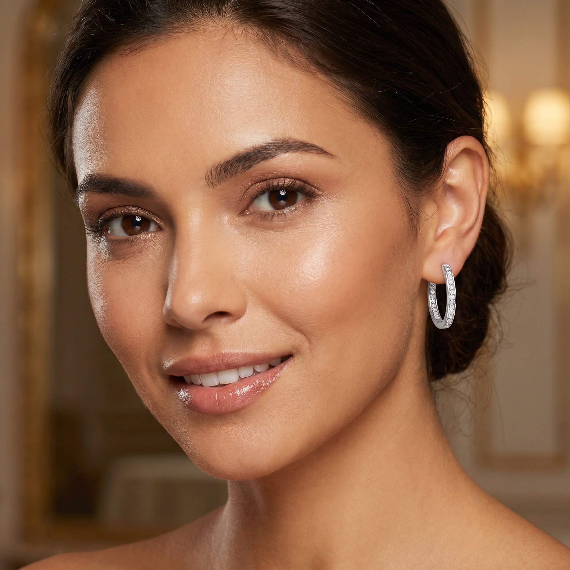 Woman wearing Engelsrufer inside out CZ 24mm silver hoop earrings.
