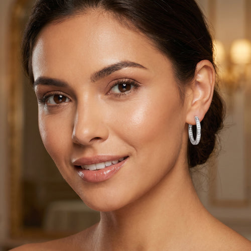 Woman wearing Engelsrufer inside out CZ 24mm silver hoop earrings.