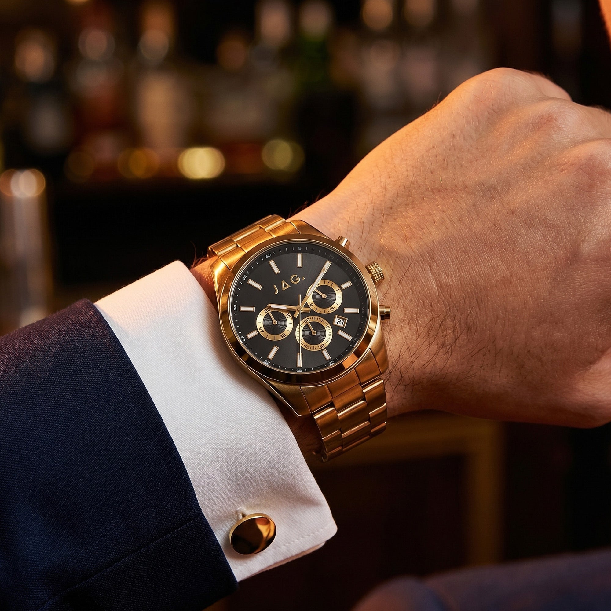 Man wearing JAG Acton men's black dial gold watch on his wrist.