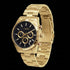Side tilt view of JAG Acton men's black dial gold watch.