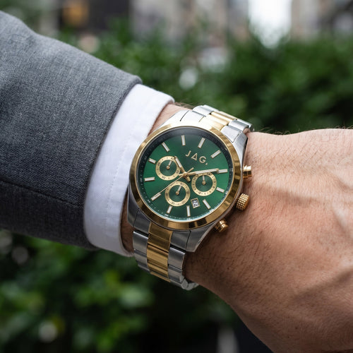 Man wearing JAG Acton men's green dial two-tone watch on his wrist.