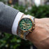 Man wearing JAG Acton men's green dial two-tone watch on his wrist.