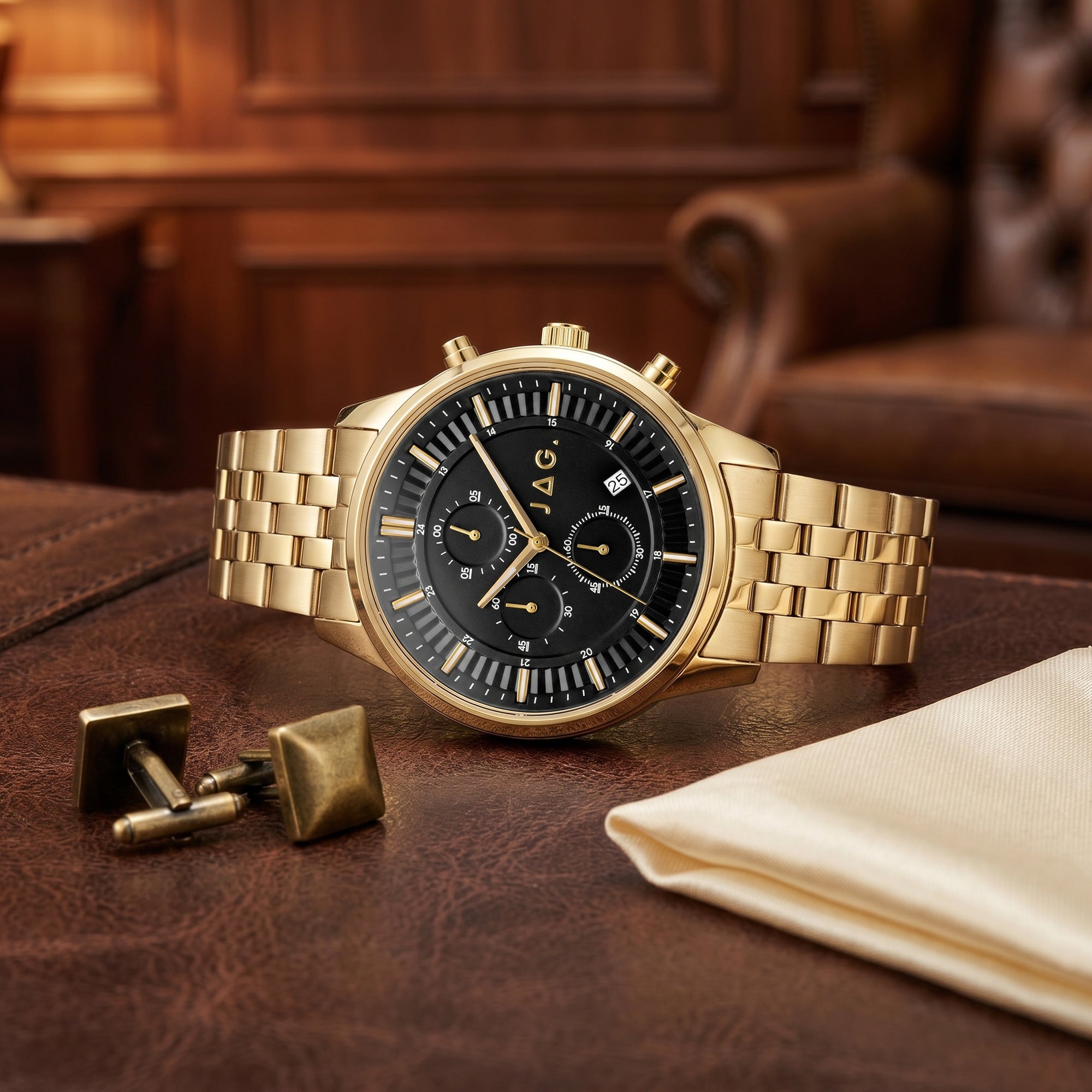 JAG Albany men's black dial gold watch on a leather desktop in a man's study.