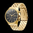 Side tilt view of JAG Albany men's black dial gold watch.