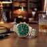 JAG Albany men's green dial two-tone watch on a wooden desk in a man's study.