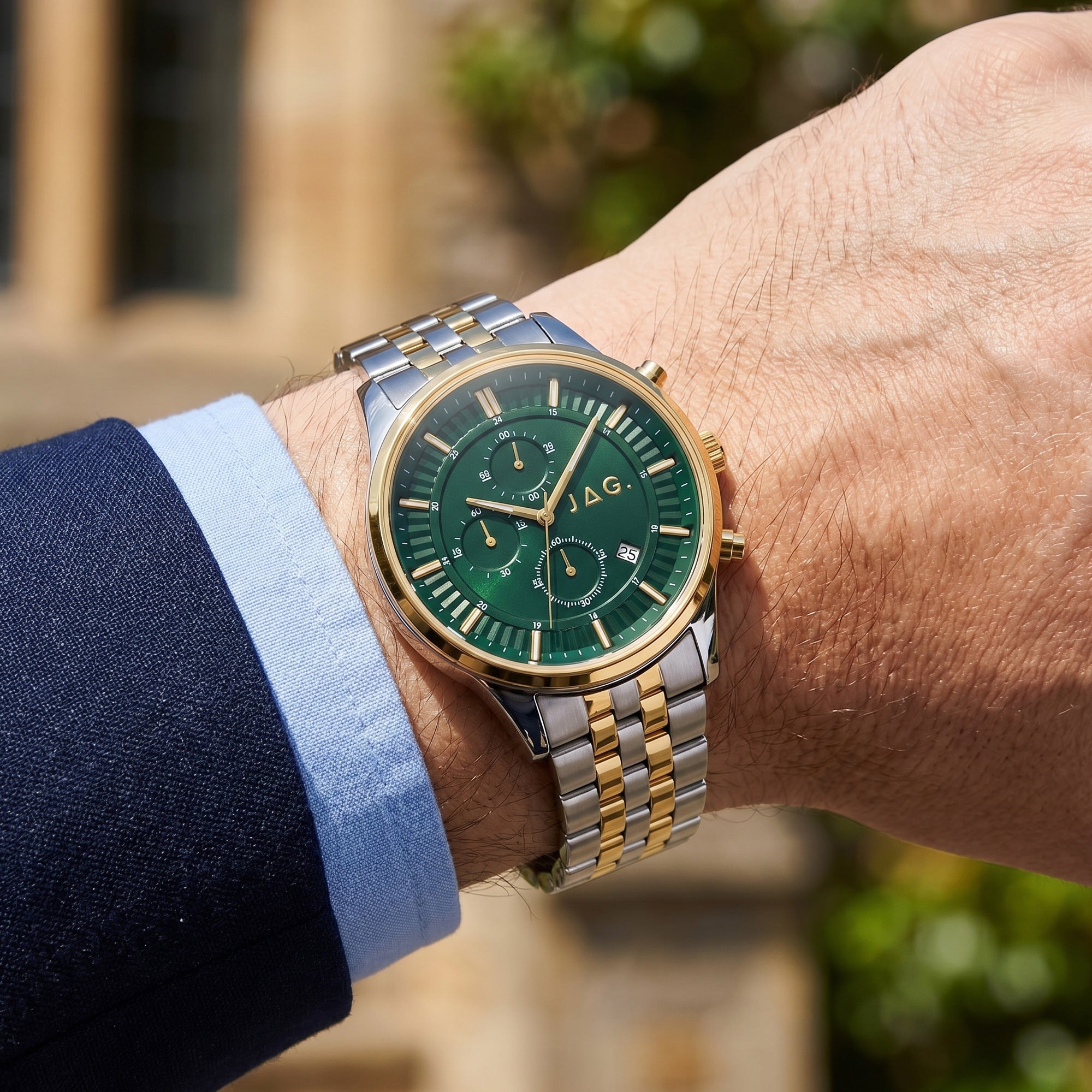 Man wearing JAG Albany men's green dial two-tone watch on his wrist.