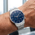 Man wearing JAG Albany men's blue dial silver watch on his wrist.