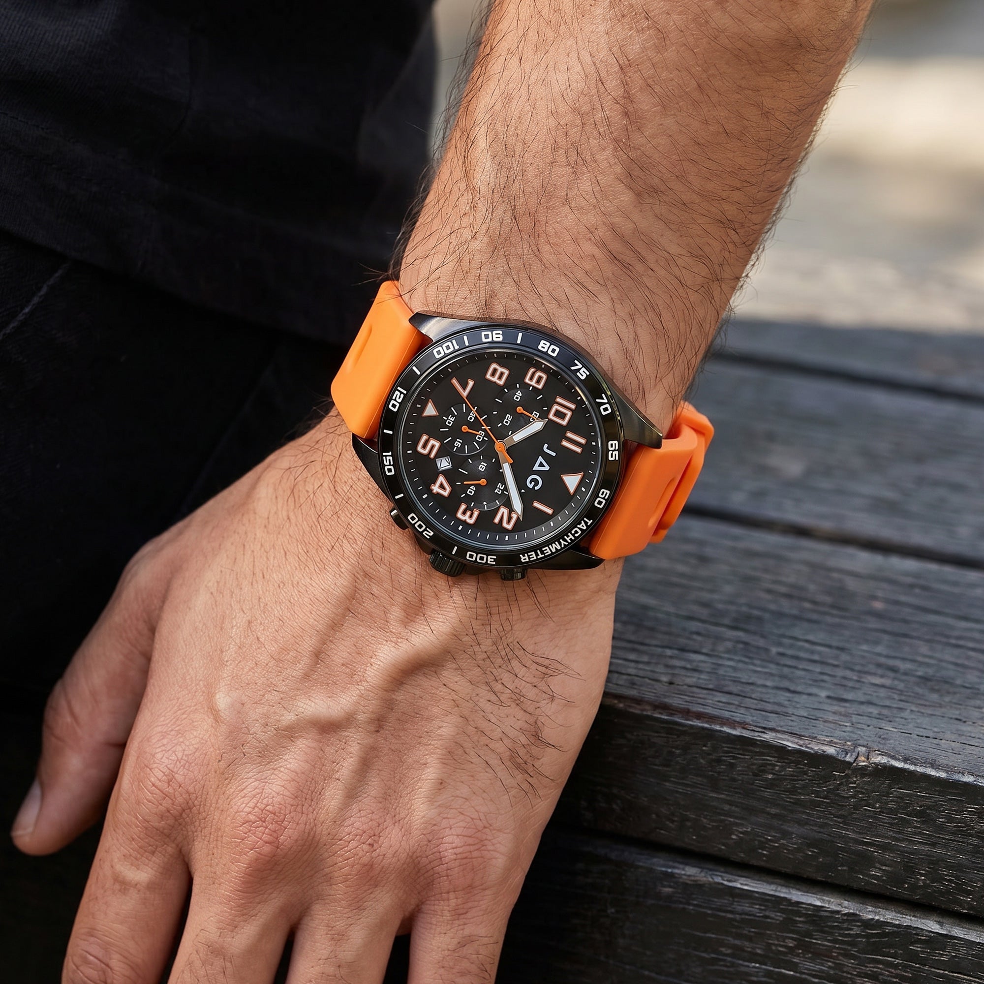 Man wearing a JAG Beachport black dial orange sport chronograph men's watch.