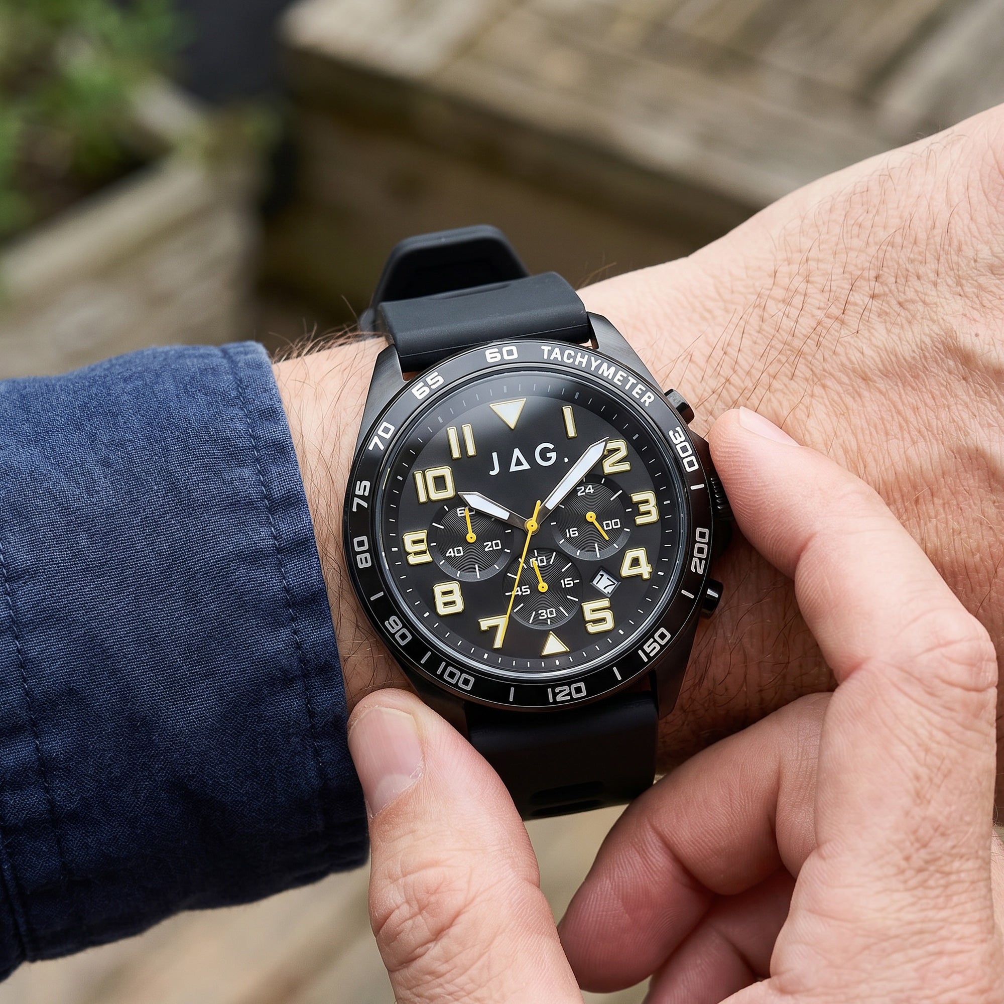 Man checking the time on his JAG Beachport black sport chronograph men's watch.
