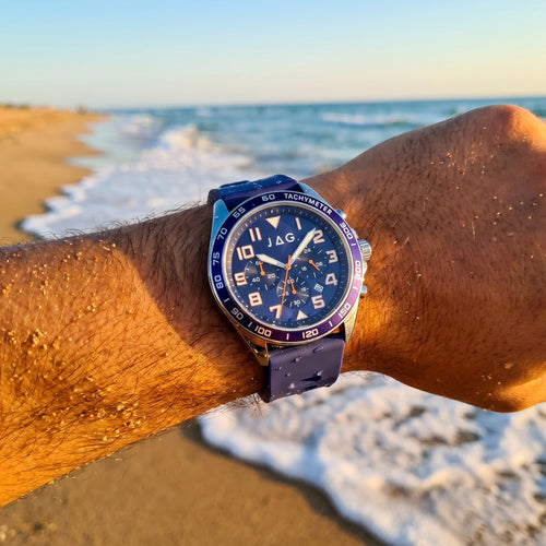 Man wearing JAG Beachport blue men's sport chronograph watch at the beach.