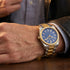 Man wearing a JAG Beaufort blue dial two-tone men's watch on his wrist.