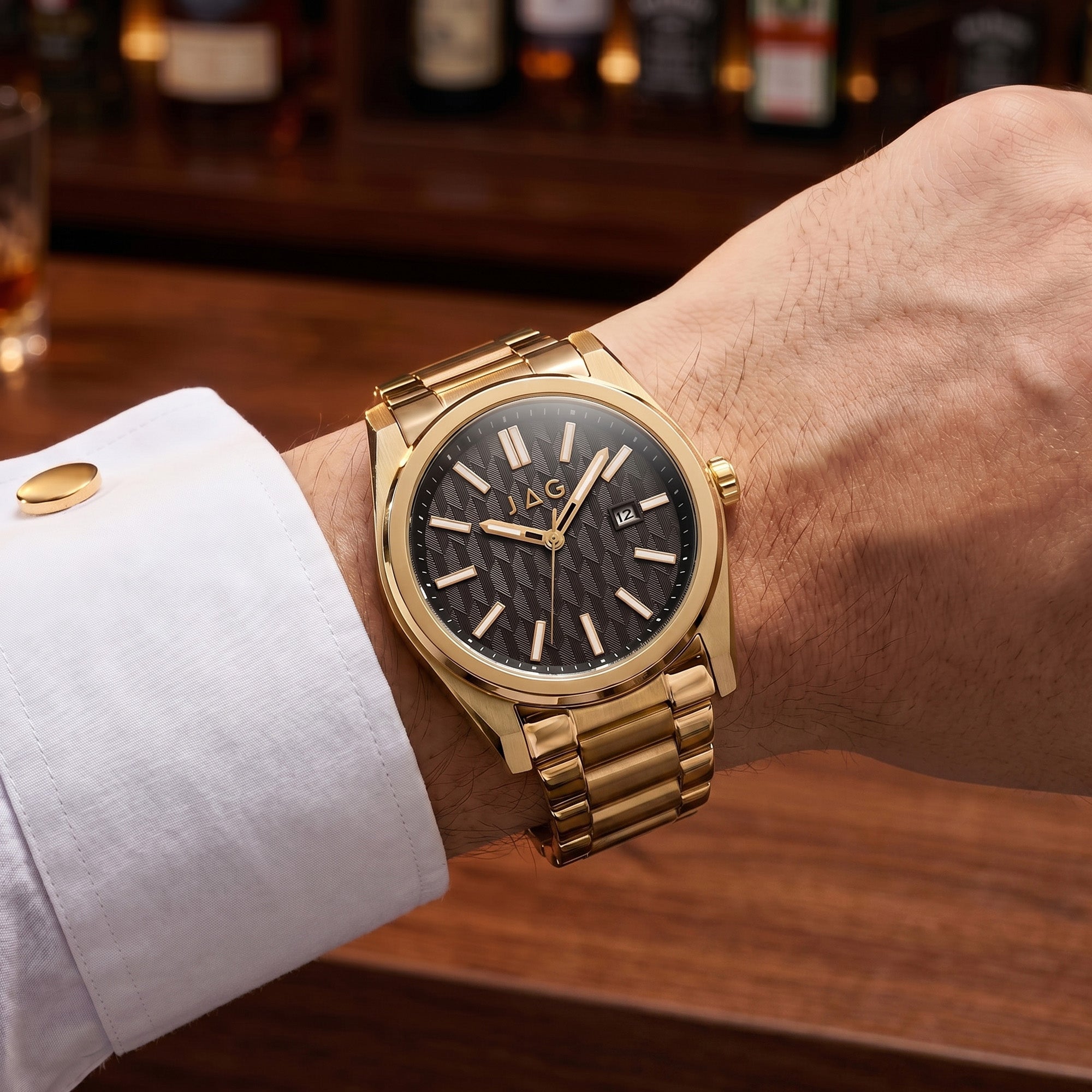 Close-up of man wearing a JAG Beaufort black dial gold men's watch on his wrist.