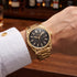 Close-up of man wearing a JAG Beaufort black dial gold men's watch on his wrist.