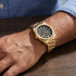 Man wearing a JAG Beaufort black dial gold men's watch.