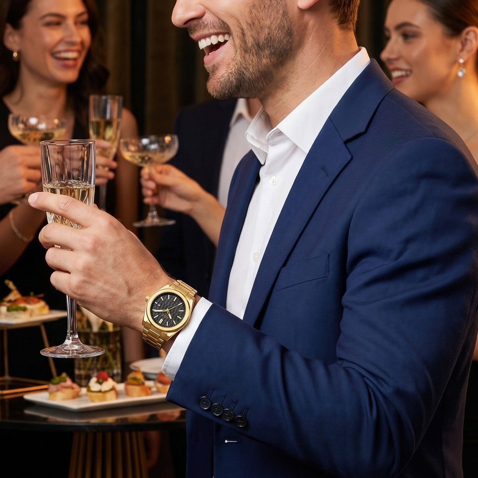 Man wearing a JAG Beaufort black dial gold men's watch surrounded by people at a social event.