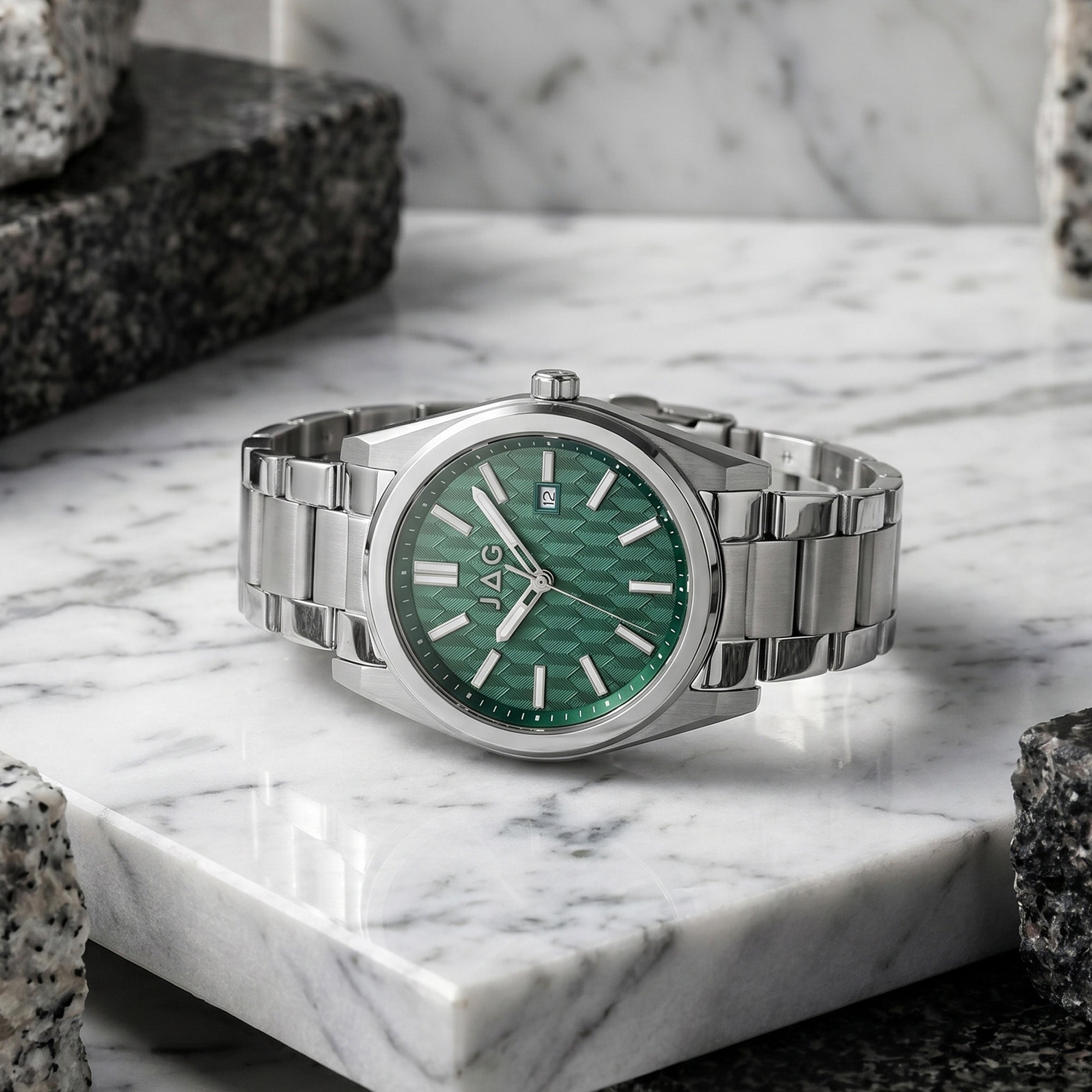 JAG Beaufort green dial silver men's watch laying on a grey marble surface.