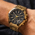 Man wearing JAG Boss black dial gold chronograph watch on his wrist.