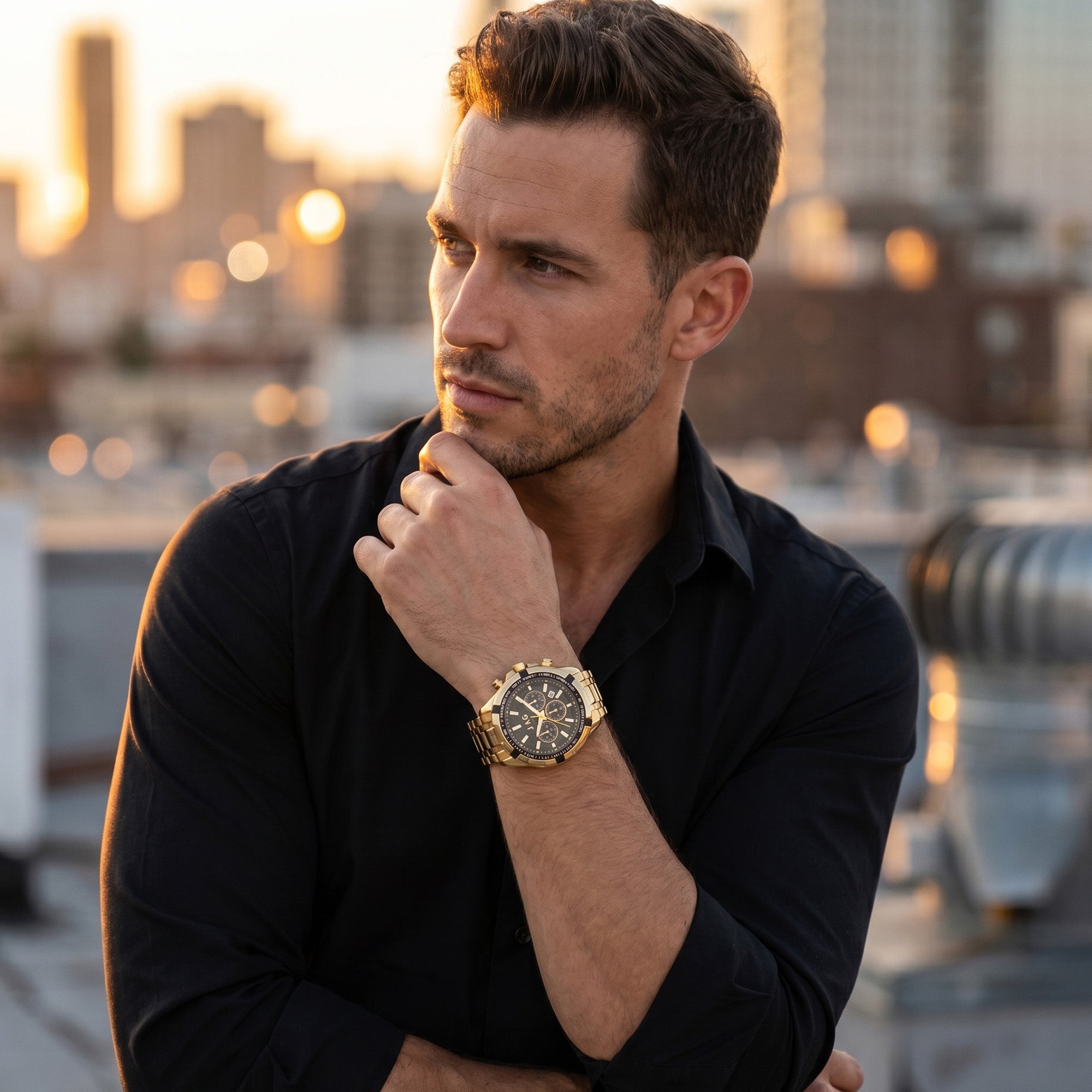 Man in a black shirt wearing a JAG Boss Black dial men's gold chronograph watch.