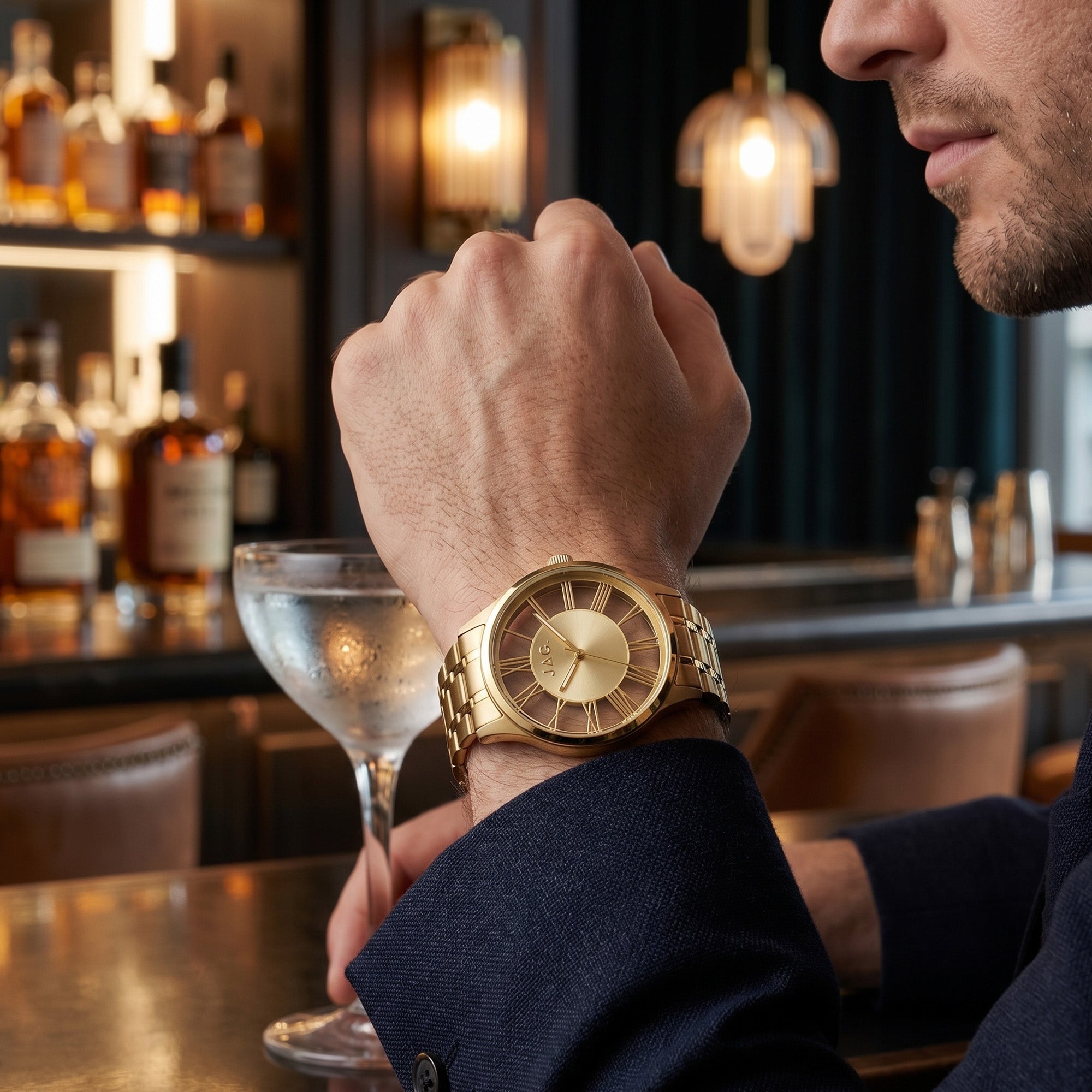 Man sitting at a bar wearing a JAG Gerroa gold transparent watch.