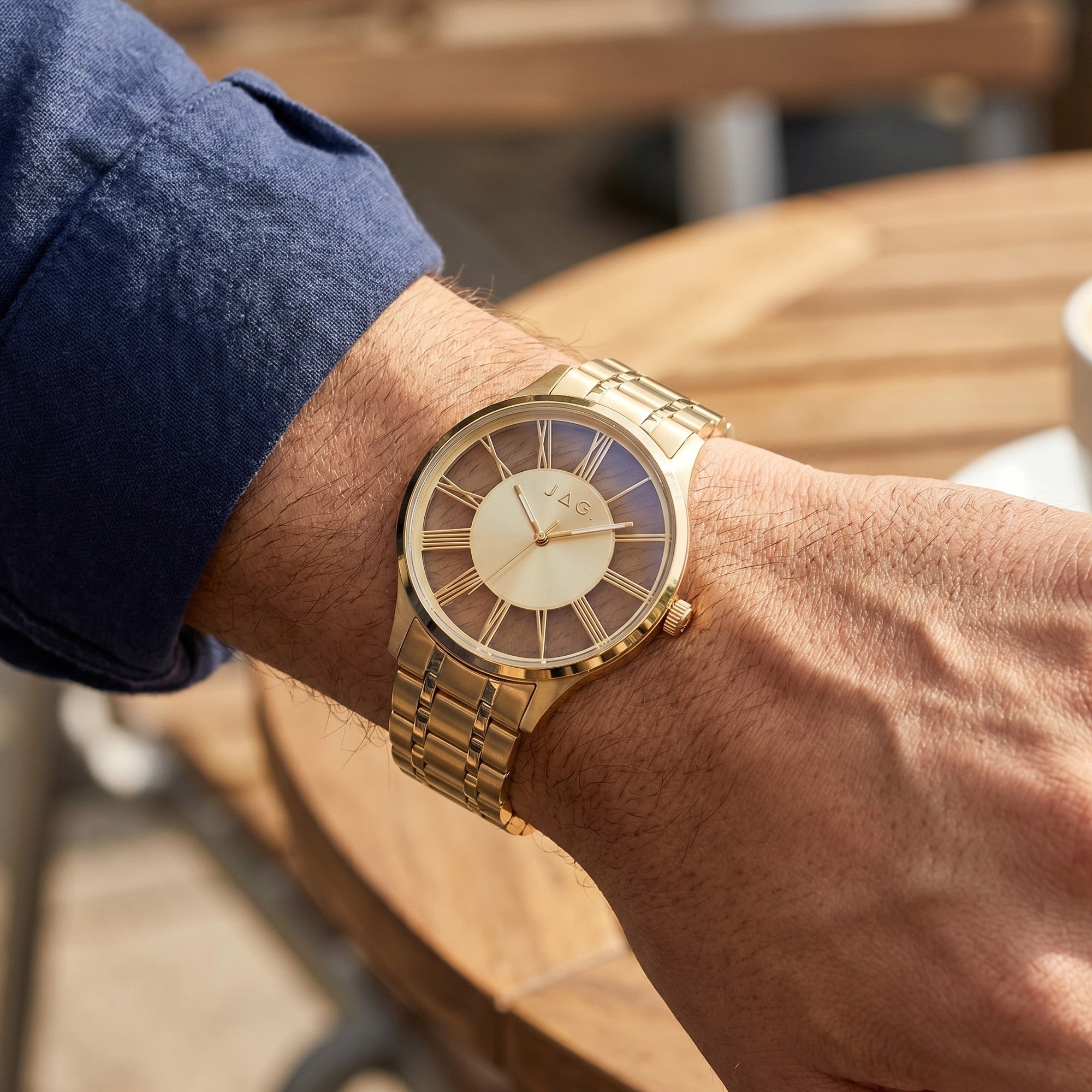 Close-up of a man wearing a JAG Gerroa gold transparent watch on his wrist.