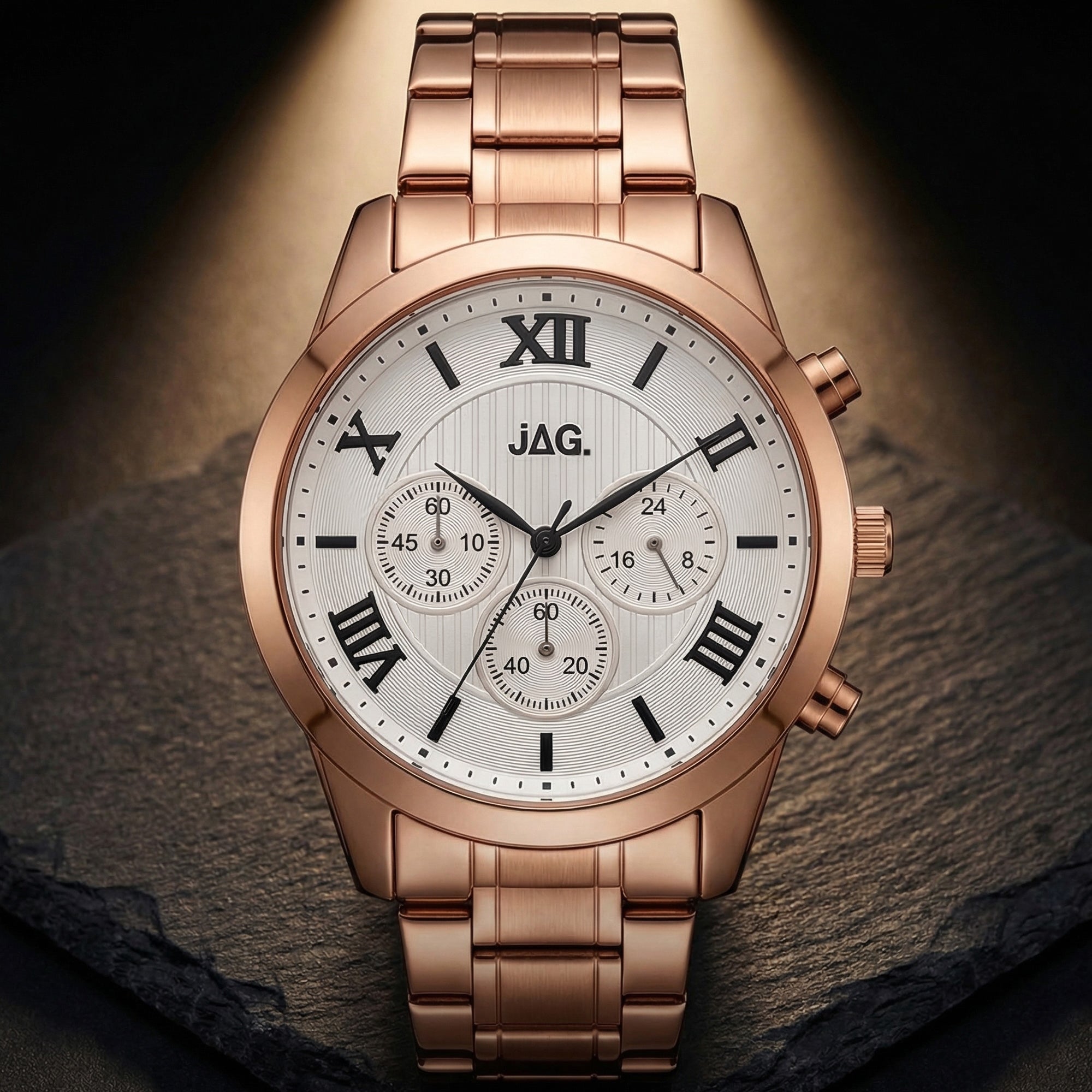 JAG ladies Estelle rose gold watch in warm spotlight against a black slate background.