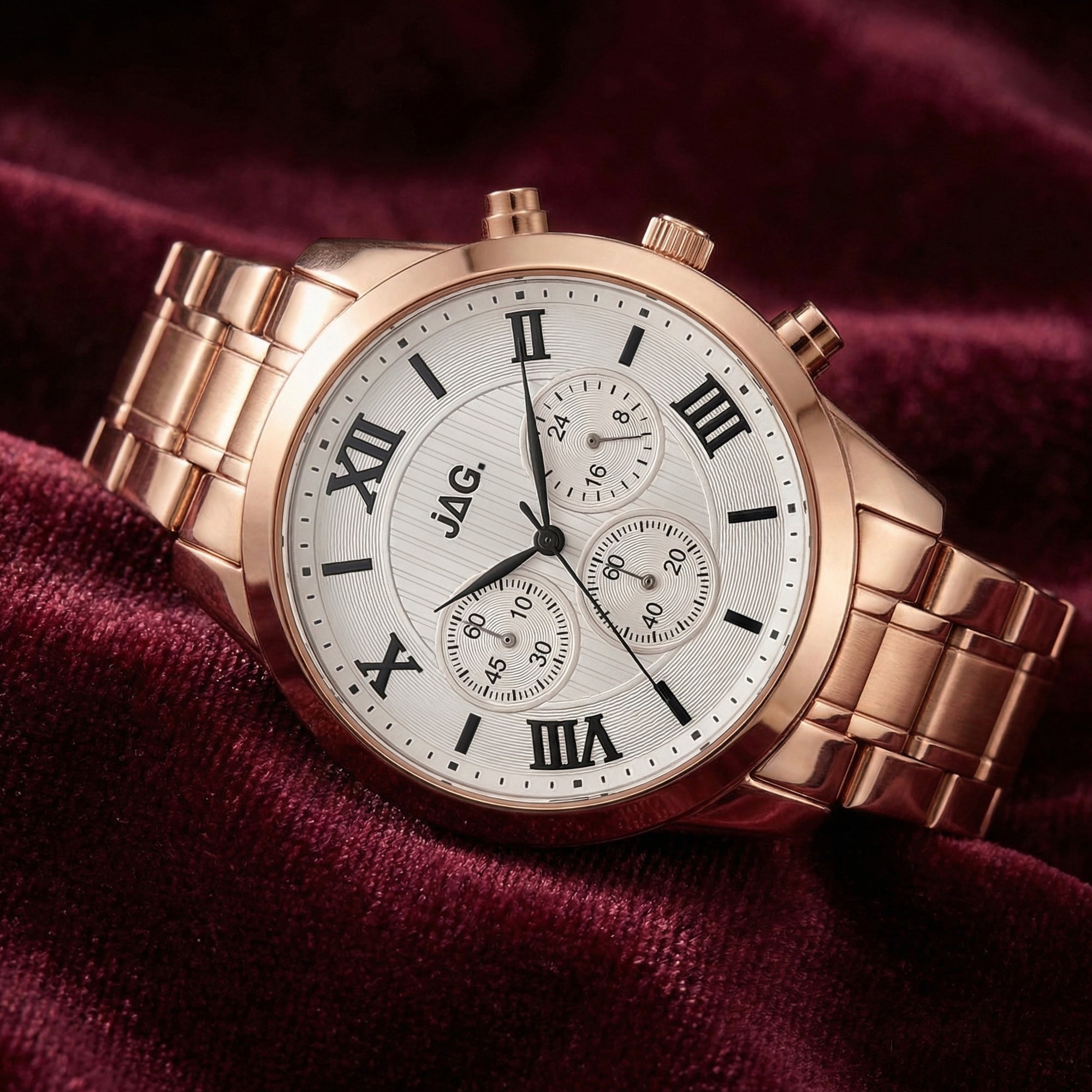 JAG ladies Estelle rose gold watch laying on red velvet fabric.