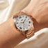 Woman wearing JAG ladies Estelle rose gold watch.