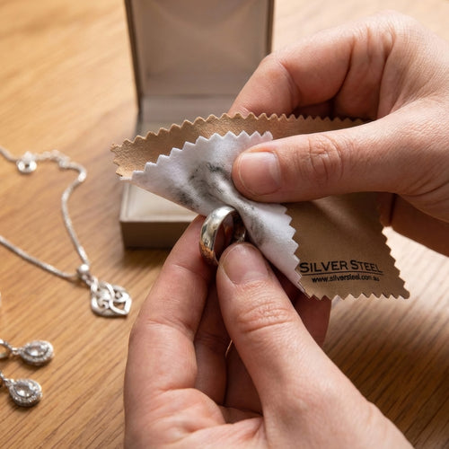 Sterling silver ring being polished with a jewellery cleaning and polishing cloth.