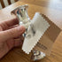 Sterling silver vase being polished with a jewellery cleaning and polishing cloth.