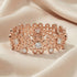 Kagi champagne bubbles rose gold cuff bracelet on soft fabric.