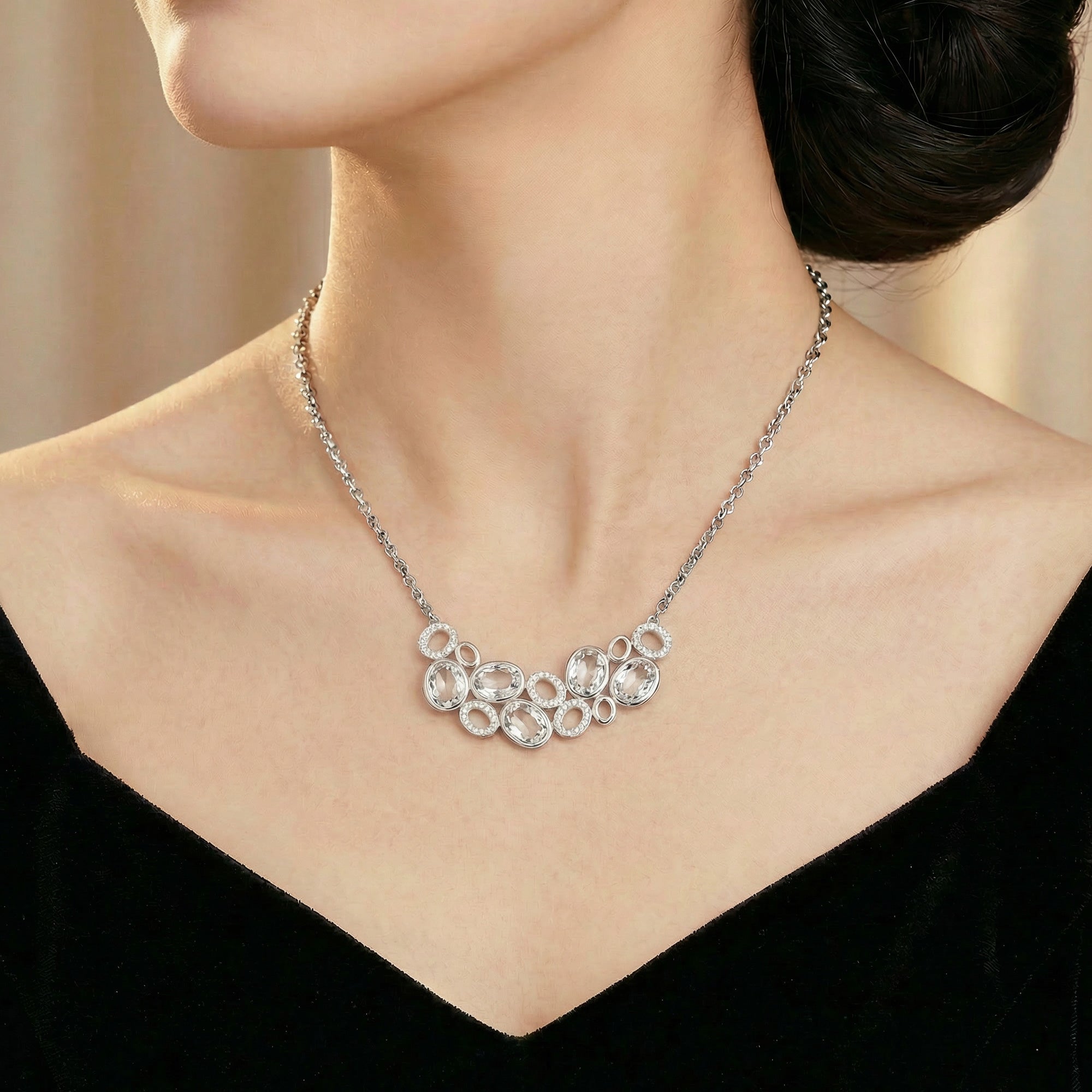 Woman wearing clear gemstone side of Kagi prismatic gemstone reversible statement necklace.
