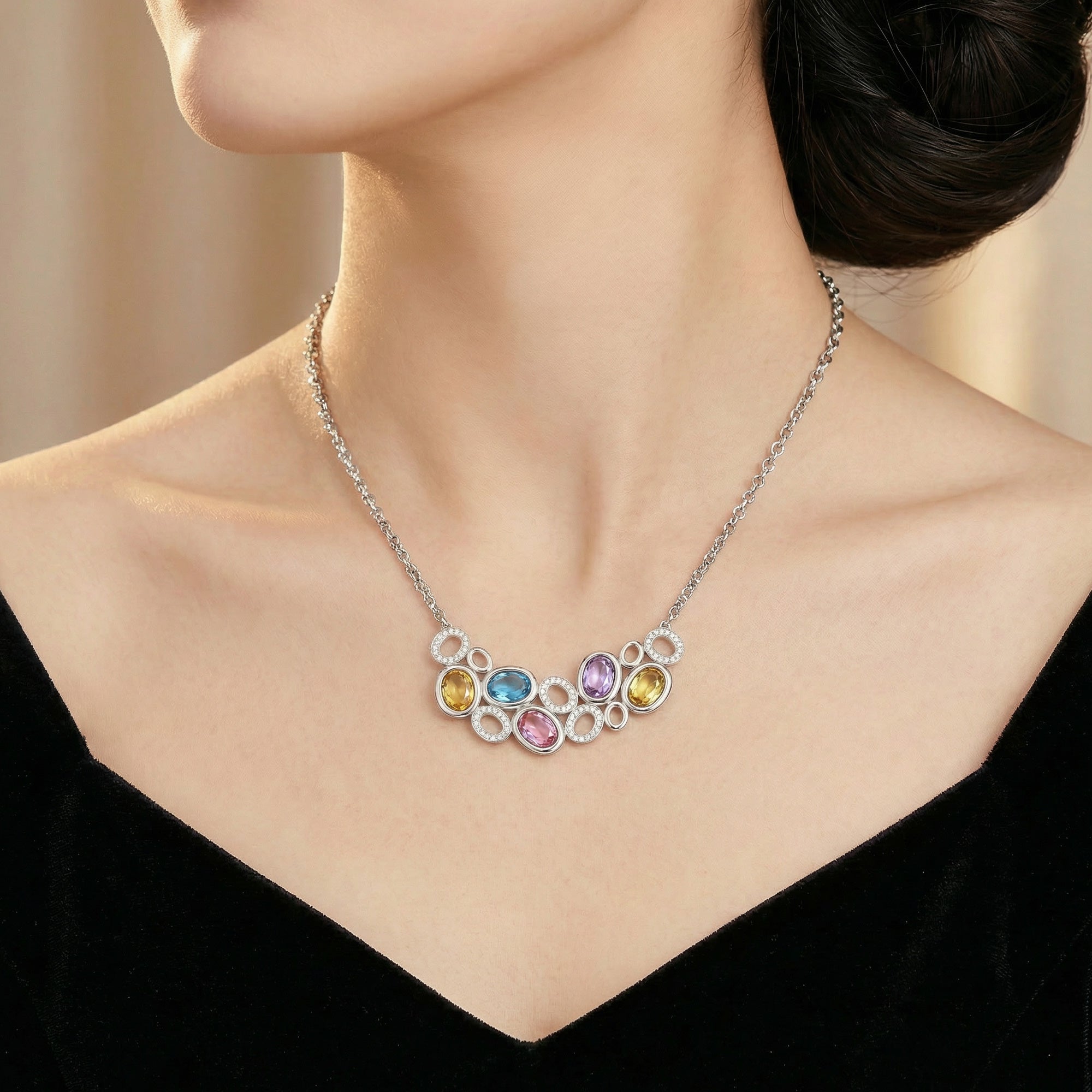 Woman wearing colour gemstone side of Kagi prismatic gemstone reversible statement necklace.