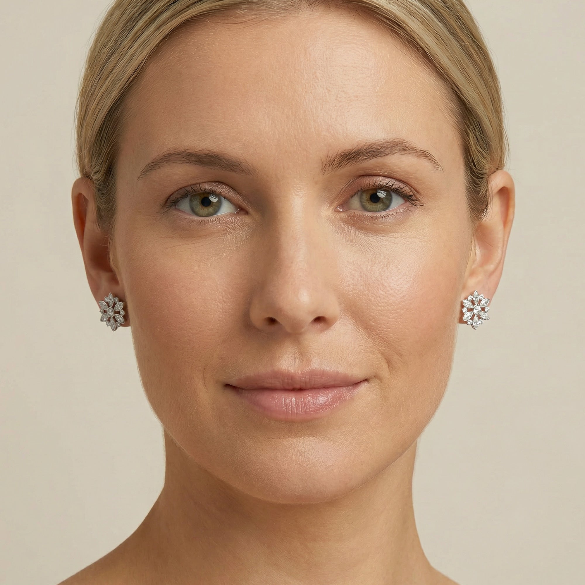Woman facing forward wearing Kagi snowflake stainless steel stud earrings.