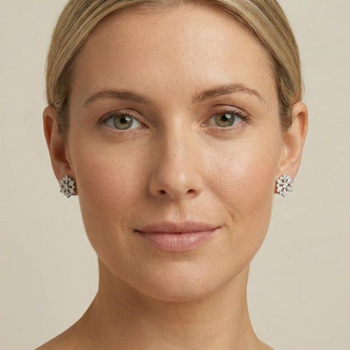 Woman facing forward wearing Kagi snowflake stainless steel stud earrings.