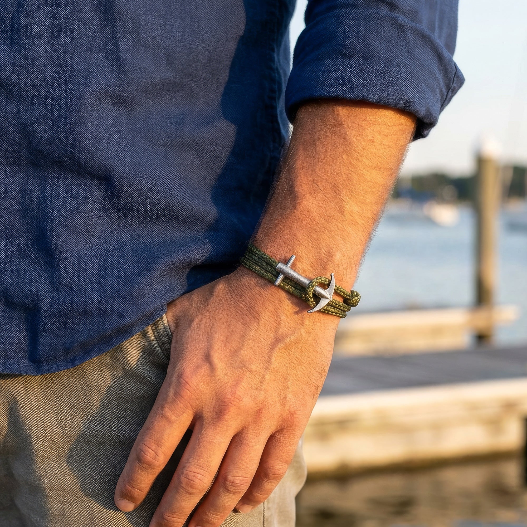 Man wearing Anchor & Crew Admiral silver khaki green rope bracelet on wrist.