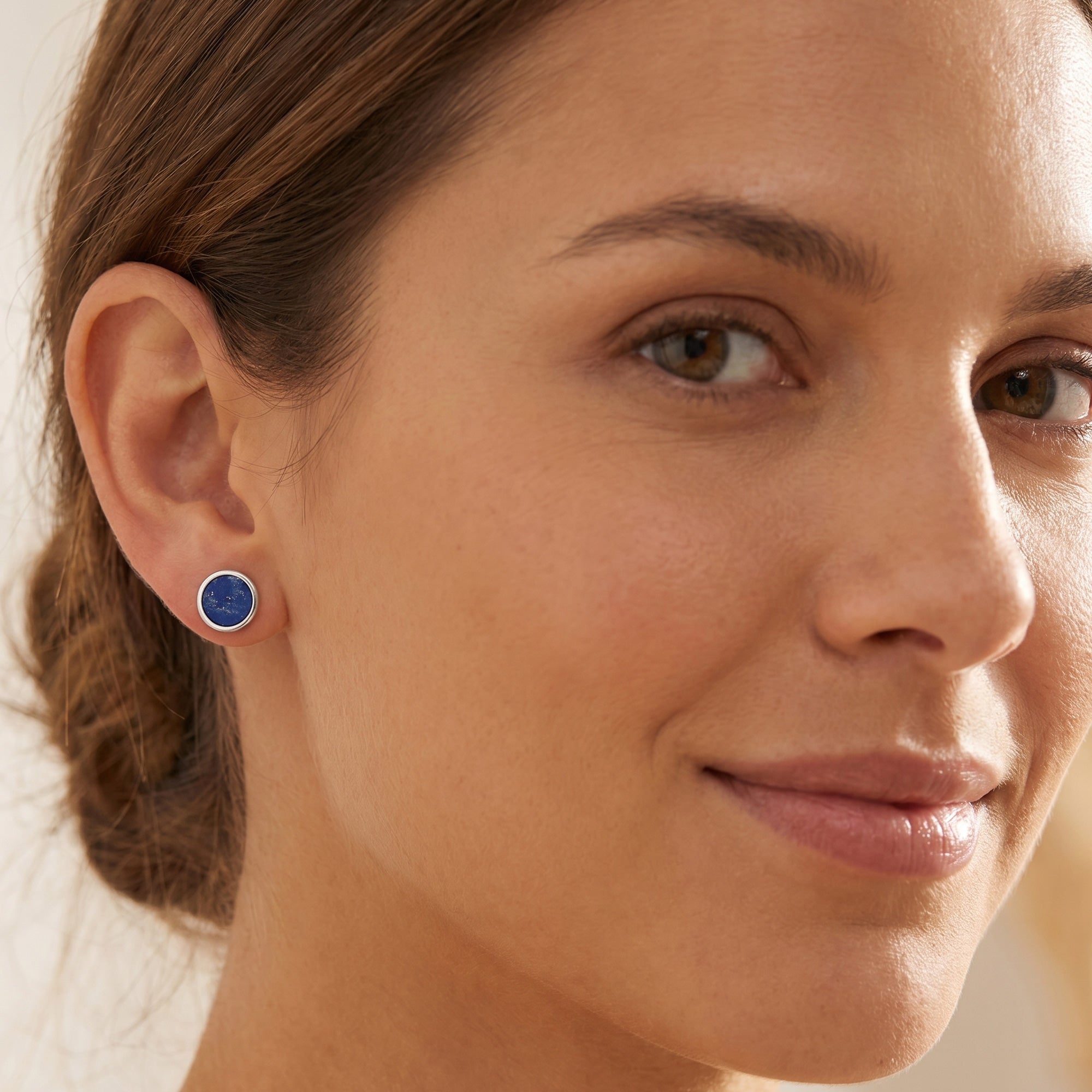 Woman wearing Engelsrufer lapis lazuli sterling silver circle earrings.