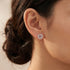 Woman wearing Engelsrufer lotus flower circle CZ stud earrings.