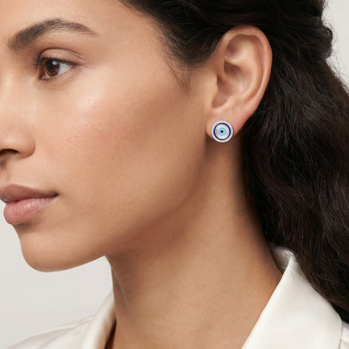 Woman wearing Engelsrufer lucky eye silver blue enamel circle earrings.
