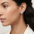 Woman wearing Engelsrufer lucky eye silver blue enamel circle earrings.