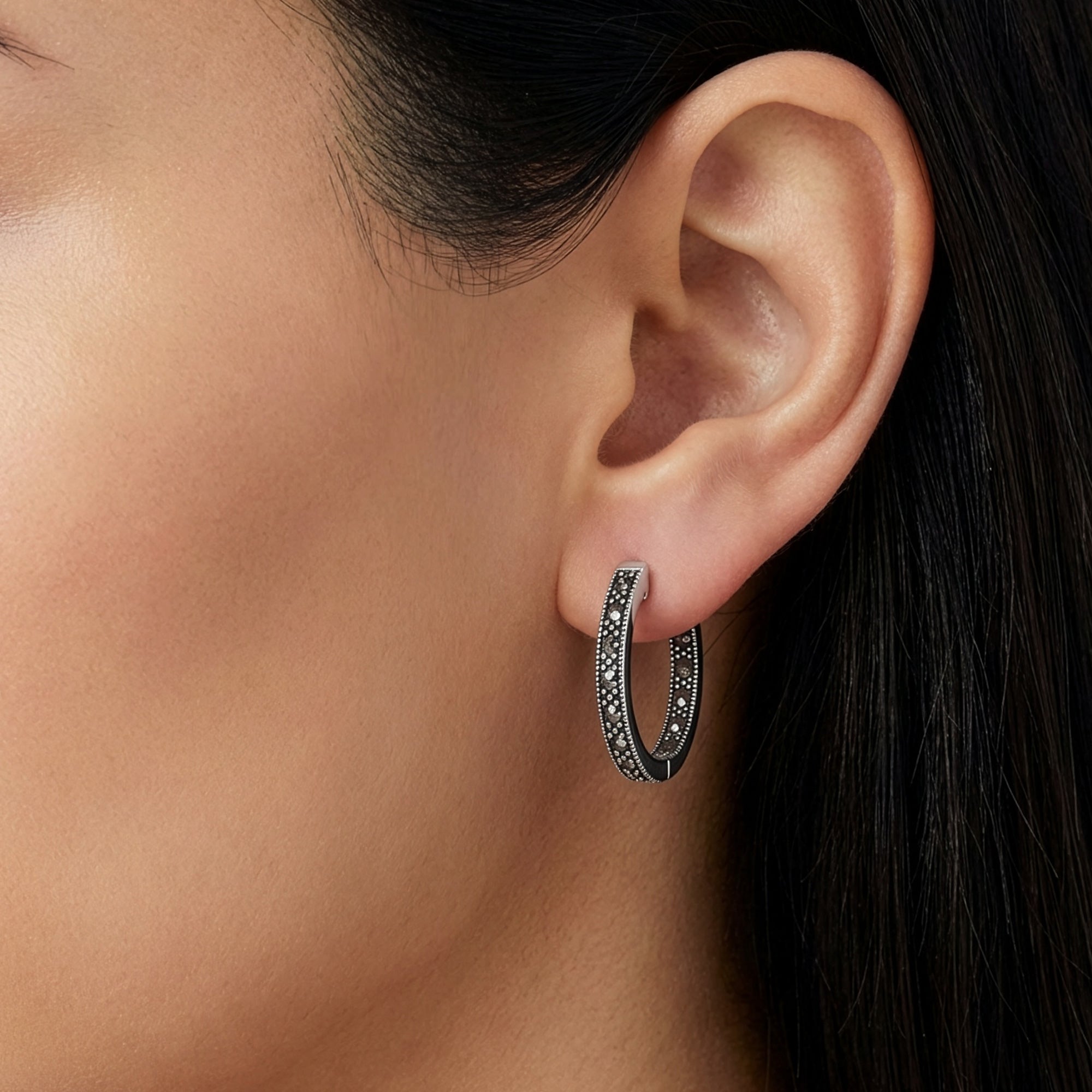 Close-up of a woman wearing sterling silver marcasite creole 21.5mm hoop earrings.