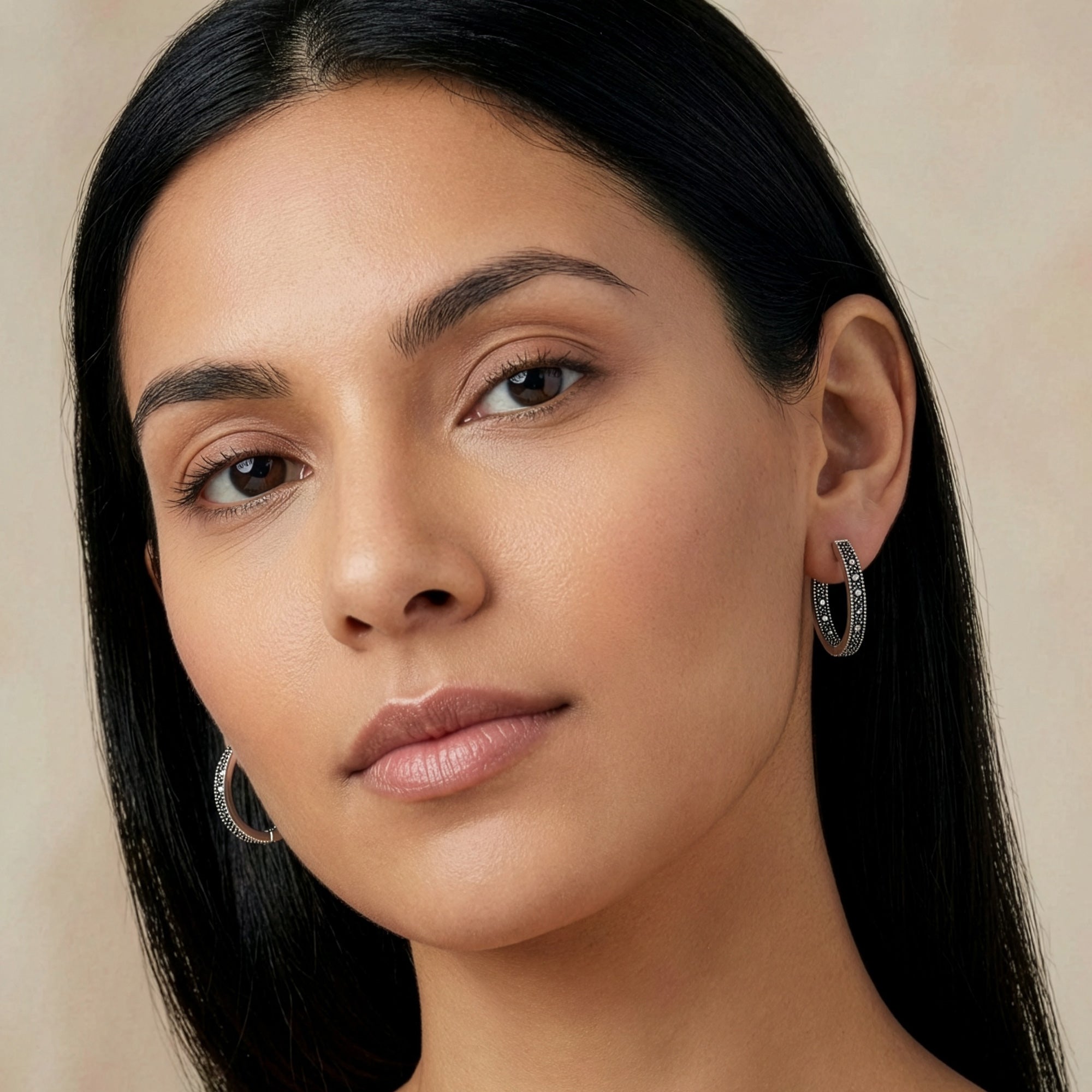 Woman wearing sterling silver marcasite creole 21.5mm hoop earrings.
