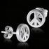 Peace symbol stainless steel stud earrings sitting on a black mirror surface.